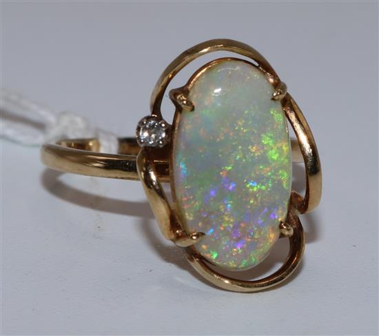 A 1980s 14ct gold, white opal and diamond set oval dress ring, size N.